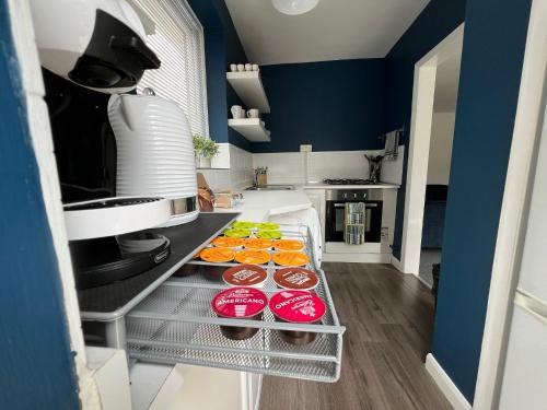 a kitchen with plates of food on a shelf at Peaceful location with FREE parking for 2 cars - hosts up to 4- business or leisure stays, inc hot-tub-Netflix-complimentary breakfast in Southampton