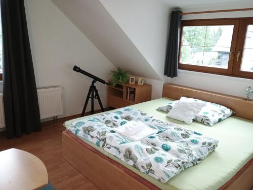 a bedroom with a bed with a camera on a tripod at Bedřichov 298 in Bedřichov
