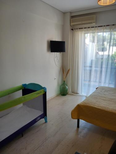a bedroom with a bed and a television in a room at Cozy Karystos Apartment in Karistos
