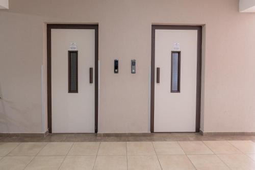 four doors in a wall with frames on them at Daria Apartment in Bitola in Bitola
