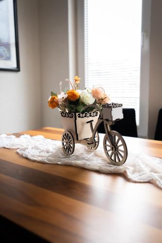 a cart with flowers on top of a table at Daria Apartment in Bitola in Bitola