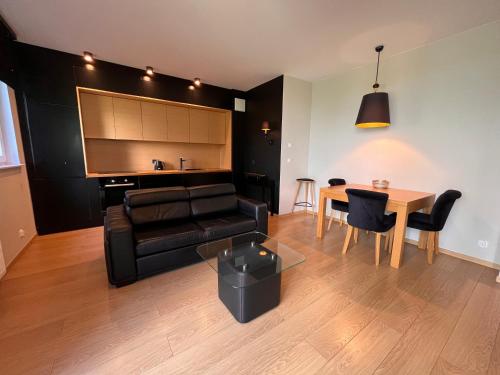 a living room with a couch and a table at INA Rent - Tre Mare Apartamenty in Gdańsk