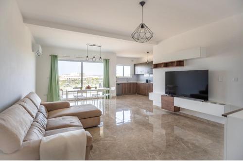a living room with a couch and a television at 3 bedroom apartment in Gudja in Gudja