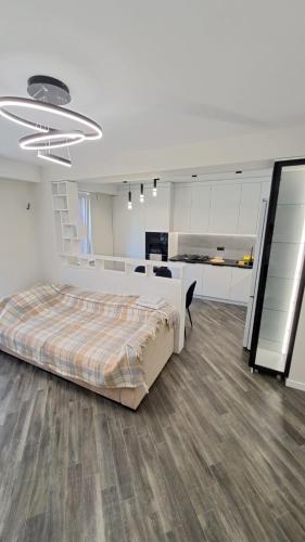 a bedroom with a large bed and a kitchen at AIRPORT&APARTMENT&parking in Chişinău
