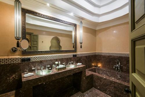 a bathroom with two sinks and a large mirror at Almaha Marrakech Restaurant & SPA in Marrakech