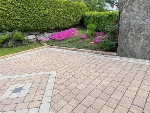 a garden with purple and pink flowers and bushes at Apart Alpenview in Umhausen