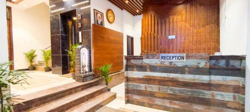 a hotel lobby with a sign that reads reception at Hotel Lake View Chandigarh in Chandīgarh