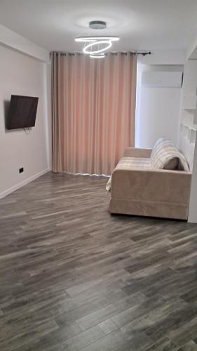 a bedroom with a bed and a flat screen tv at AIRPORT&APARTMENT&parking in Chişinău