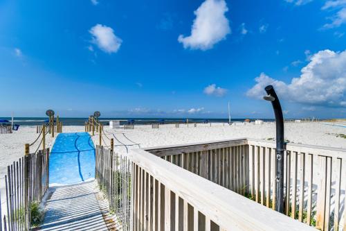 a beach with a blue slide on the beach at Beachfront Condo in Gulf Shores with Pool Access! in Gulf Shores