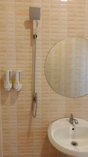 a bathroom with a sink and a mirror at Pai Family House in Pai