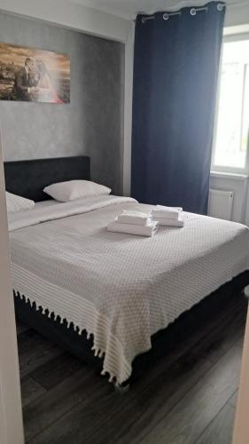 a bedroom with a bed with two trays on it at AIRPORT&APARTMENT&parking in Chişinău