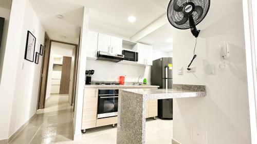 a kitchen with white walls and a counter top at Apartamentos en Club Residencial in Ibagué