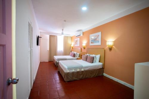 a hotel room with two beds and a corridor at Hotel Tropicus Boutique in Puerto Vallarta