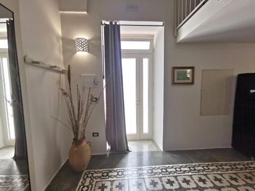 a hallway with a vase with a plant in it at Aquarius Salento in Acquarica del Capo