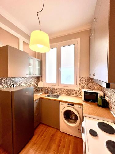 a kitchen with a refrigerator and a washing machine at Jo&Ju Prime Syntagma in Athens