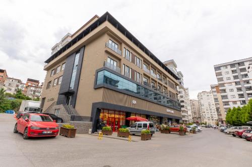 a building with a red car parked in a parking lot at TRAY TRABZON in Yomra
