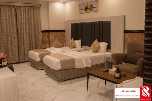 a hotel room with two beds and a couch at سيتى للشقق المخدومة in Jeddah