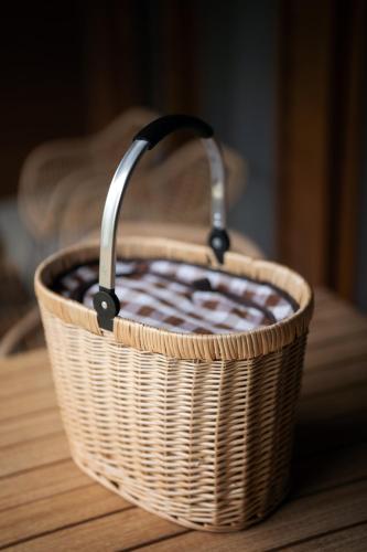 a wicker basket sitting on a wooden table at Alma do Pico - Nature Residence in Madalena