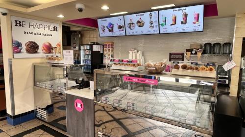 a bakery with donuts on display in a store at Howard Johnson Plaza by Wyndham by the Falls Niagara Falls in Niagara Falls