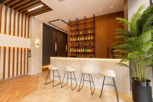 a bar with white stools in front of a counter at TRAY TRABZON in Yomra