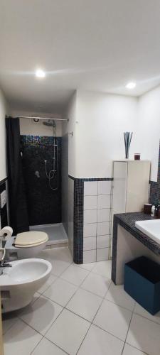 a bathroom with a shower and a toilet and a sink at casa erica in Piombino