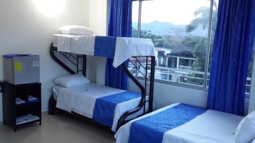 Ένα ή περισσότερα κρεβάτια σε δωμάτιο στο Tropical Resort Tocaima