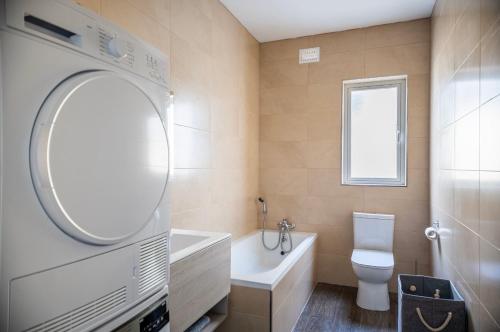 e bagno con vasca, servizi igienici e lavandino. di 3 bedroom apartment in Gudja a Gudja