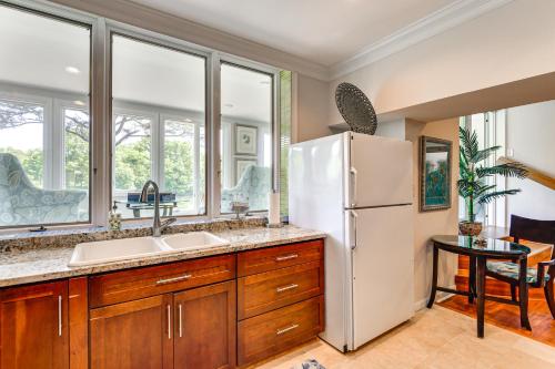 a kitchen with a sink and a refrigerator at Waterfront Columbia Studio with Patio and Sunroom! in Columbia