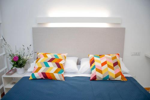 a bedroom with a bed with colorful pillows at La Risacca in Cetara