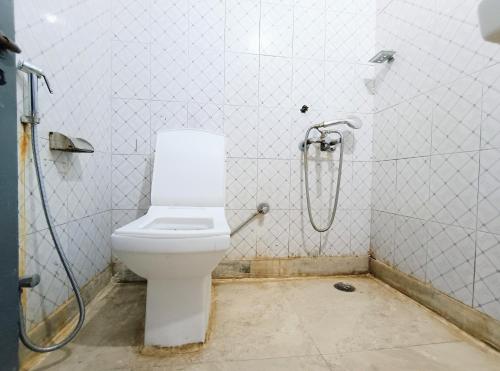 a bathroom with a toilet and a shower at Hotel Hauz Khas Fort View in New Delhi