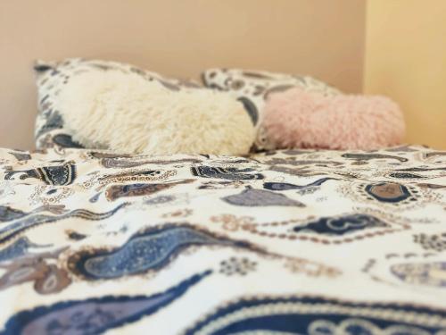 two pillows sitting on top of a bed at Ada Belgrade Apartment in Belgrade