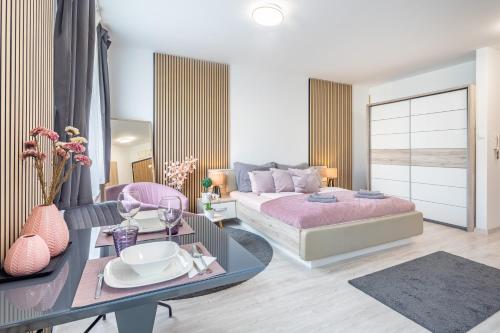 a bedroom with a bed and a table with a table at Cozy studio at residential area - free street parking in Budapest
