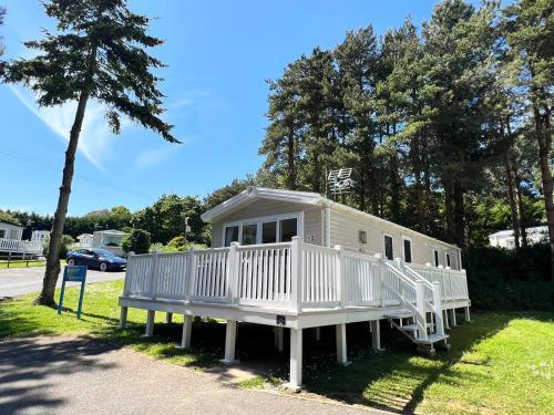 a small white house on the side of a road at 3 Bedroom Caravan LG17, Shanklin, Isle of Wight in Shanklin