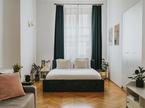 a bedroom with a bed and a couch at S18 Apartments in Kraków