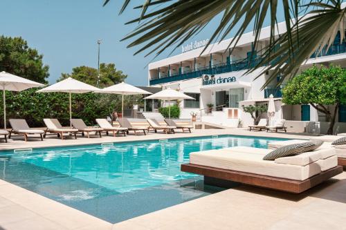 a swimming pool with lounge chairs and a hotel at Danae Hotel in Aegina Town