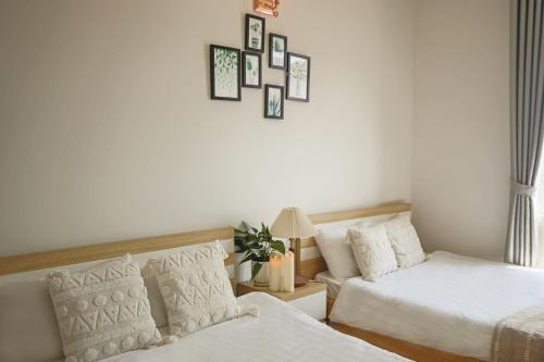 a living room with two beds and a couch at Huong Anh DaLat Palace in Da Lat