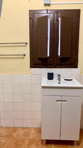 a bathroom with a white sink and a mirror at Casa da Tia Julia in Avis