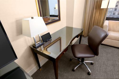 a desk with a lamp and a chair in a hotel room at Hilton Parc 55 San Francisco Union Square in San Francisco
