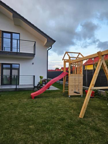 a yard with a playground with a slide at Villa Russo in Râşnov