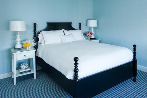 a blue bedroom with a bed and a nightstand with a bed sidx sidx sidx at Congress Hall in Cape May