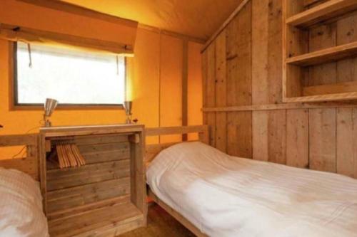 a bedroom with two bunk beds and a window at Veluwe buitenverblijf op de Glamping voor 6 personen LL55 in Putten
