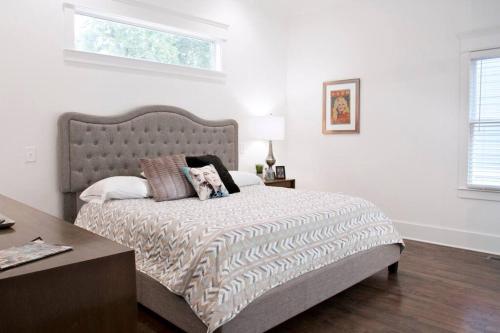 a bedroom with a large bed with a wooden floor at NEW Music Icon House in East Nashville in Nashville