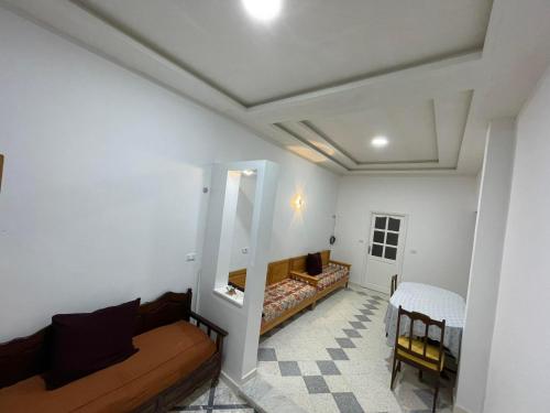 a living room with a couch and a table at Dar Zeneb in Borj el Handousse