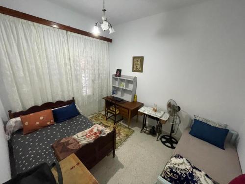 a living room with a couch and a table at Dar Zeneb in Borj el Handousse