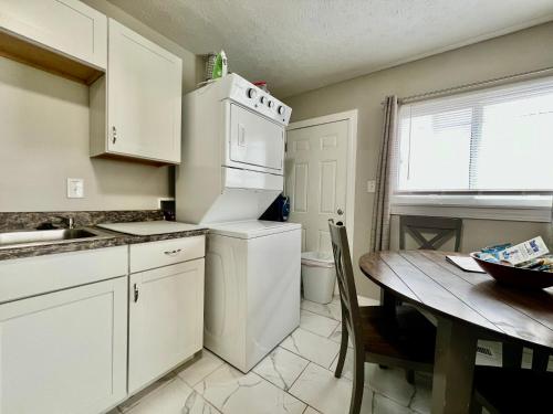 a kitchen with a table and a white refrigerator at A Great Place for Workers on Whitaker-Unit B in Hamilton
