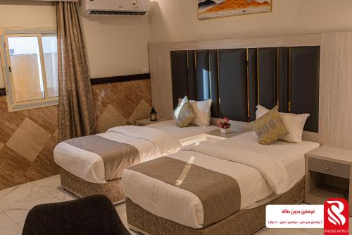 a hotel room with two beds and a window at Best Trip Hotel in Jeddah