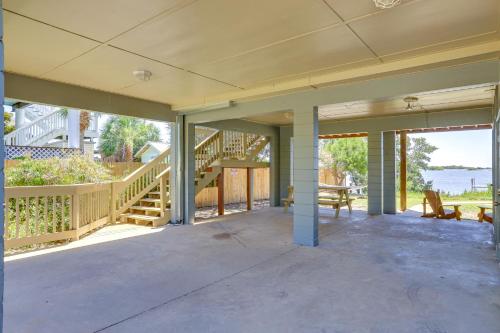 an empty porch of a house with stairs and a patio at Waterfront Duplex with Dock and Views Near Town! in Cedar Key
