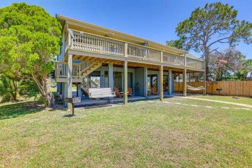 a large house with a deck and a yard at Waterfront Duplex with Dock and Views Near Town! in Cedar Key