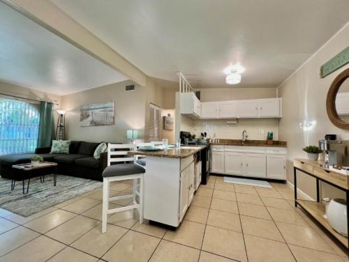 a large kitchen and living room with a couch at Coastal Retreat by TPA & Stadium in Tampa