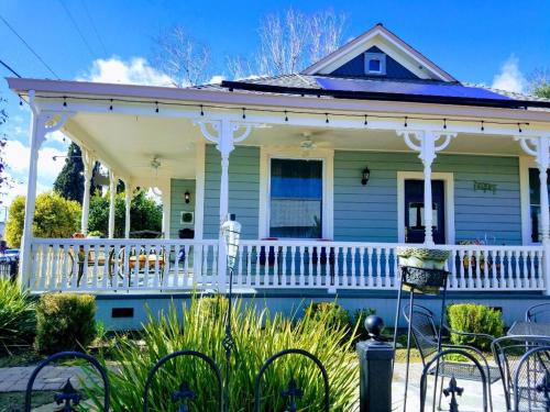 a house with a white porch with chairs at Abbey House Inn in Winters